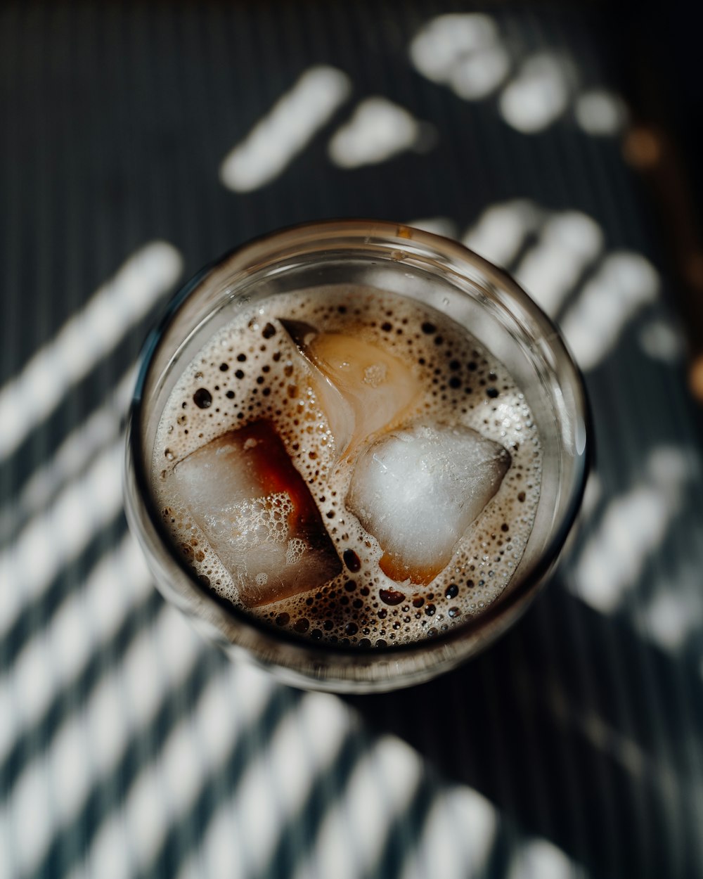 clear glass mug with brown liquid