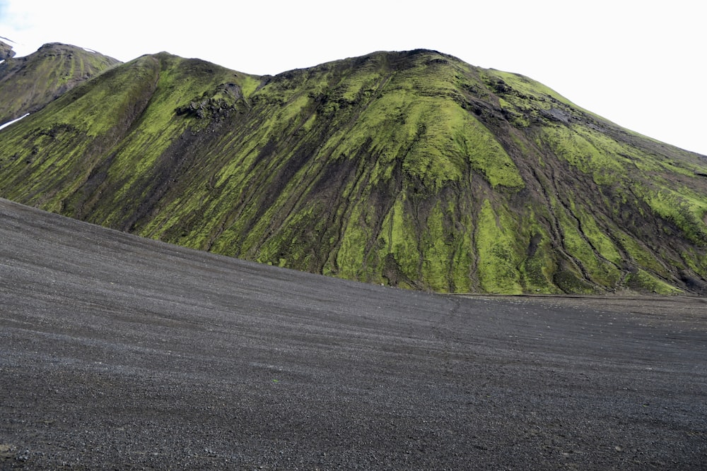 green and black mountain under white sky