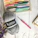 A cozy workspace with colorful yarns and knitting needles arranged neatly.