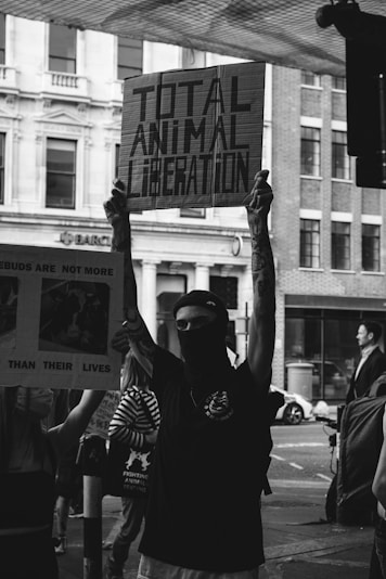 grayscale photo of man in black and white long sleeve shirt holding mans face