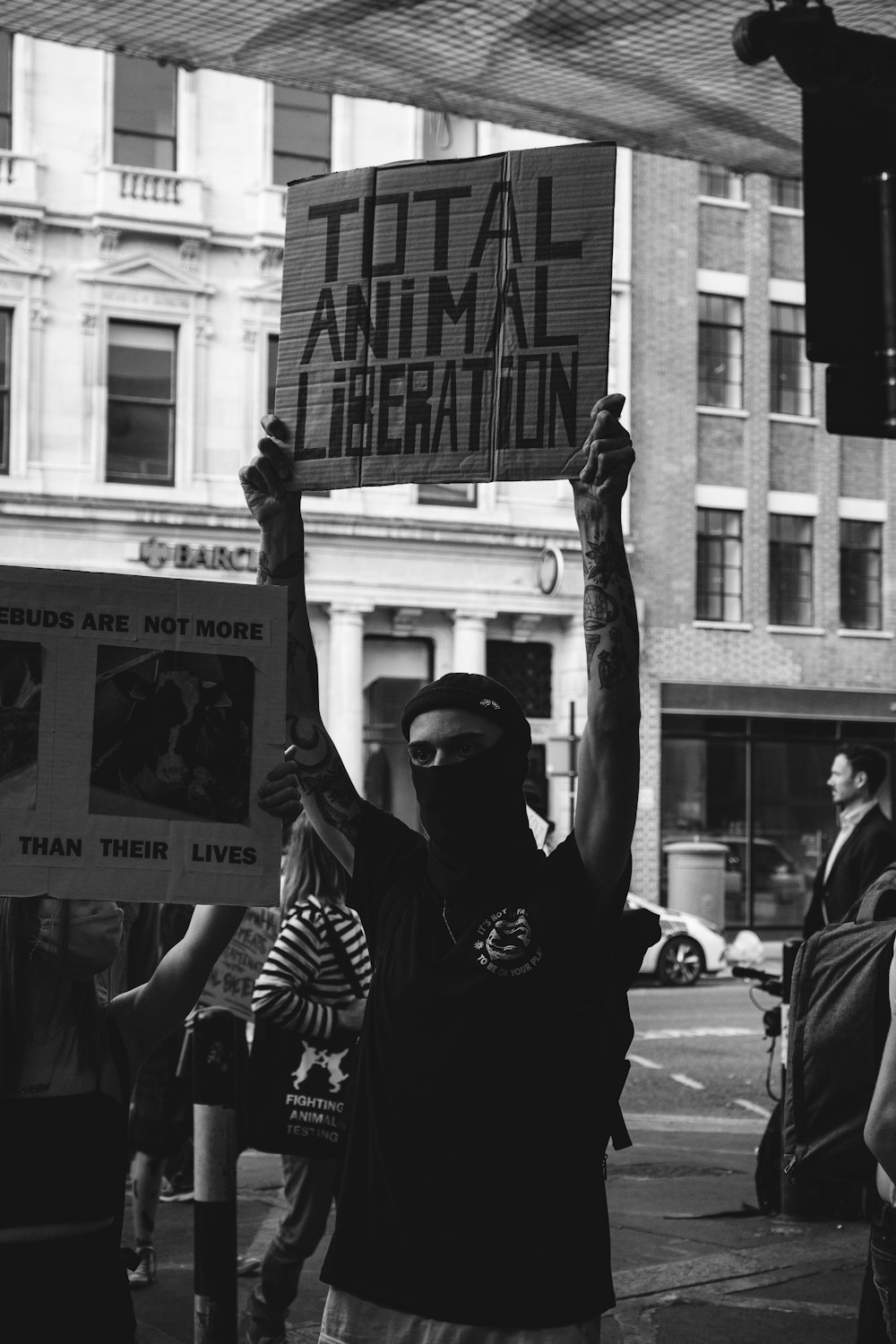 grayscale photo of man in black and white long sleeve shirt holding mans face