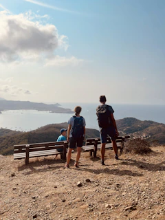 Group of happy tourists enjoying a scenic view on a Tamil Nadu hill station tour.