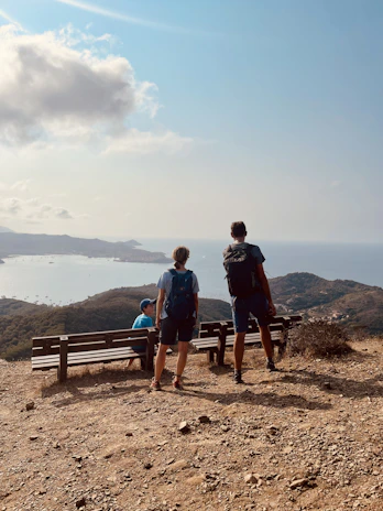 Group of happy tourists enjoying a scenic view on a Tamil Nadu hill station tour.
