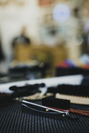Close-up of a precise beard trim and hot towel shave setup.