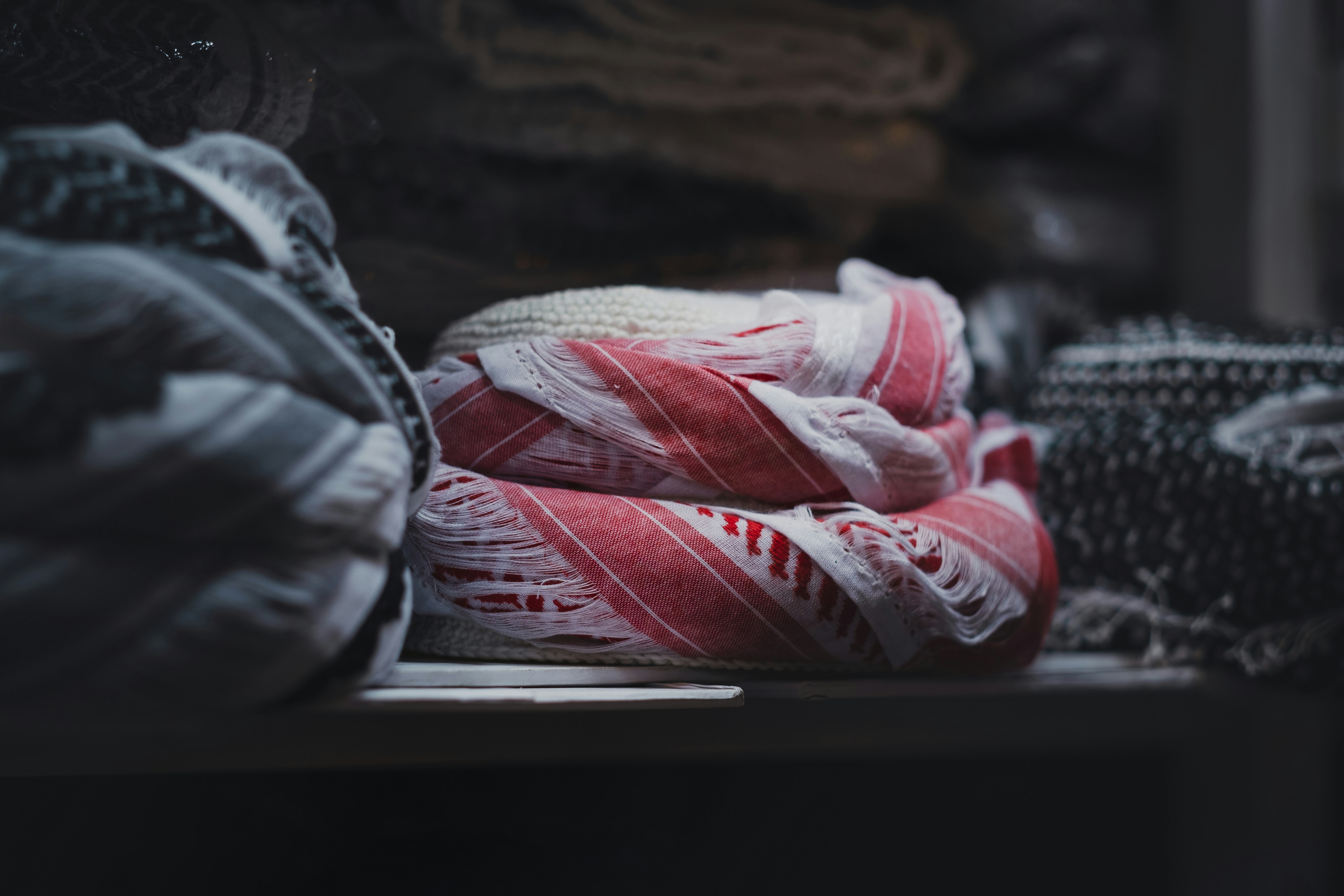 white and red sneakers on black textile