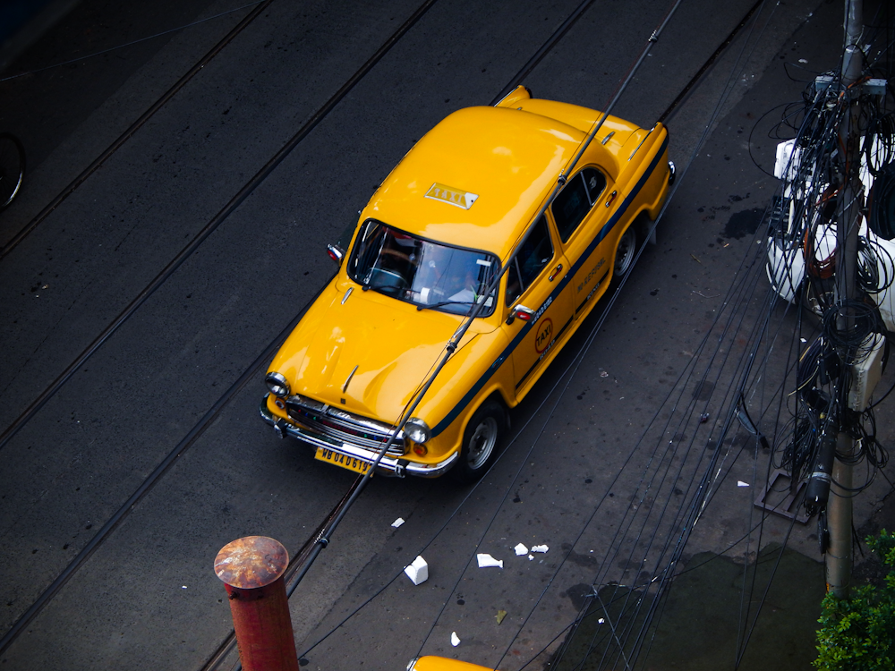 yellow car on road during daytime