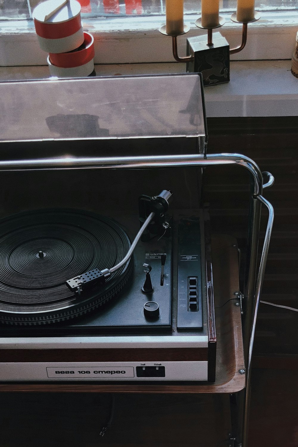 black vinyl record player on silver rack