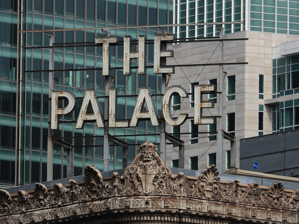a large sign that reads the palace on top of a building
