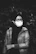 man in black jacket wearing white mask in grayscale photography