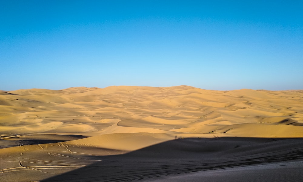 brown sand under blue sky during daytime