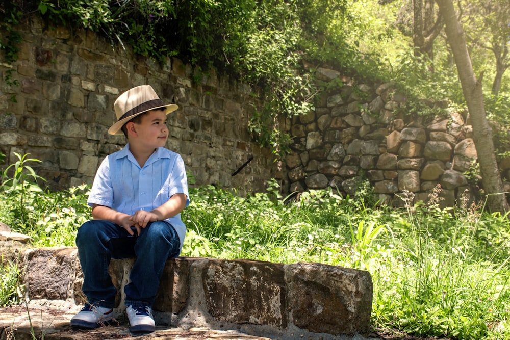 man in blue button up shirt sitting on brown concrete bench