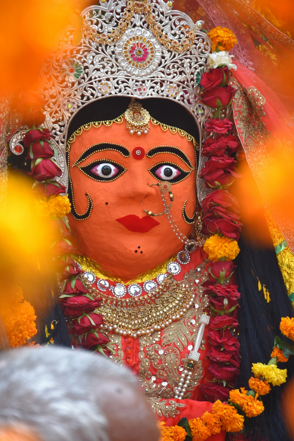 person wearing white and red floral headdress