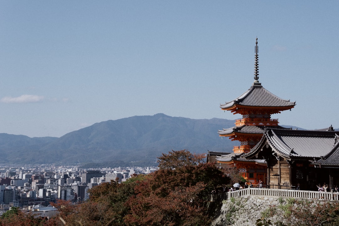 brown and white temple on top of mountain during daytime