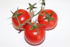 red tomato on white surface