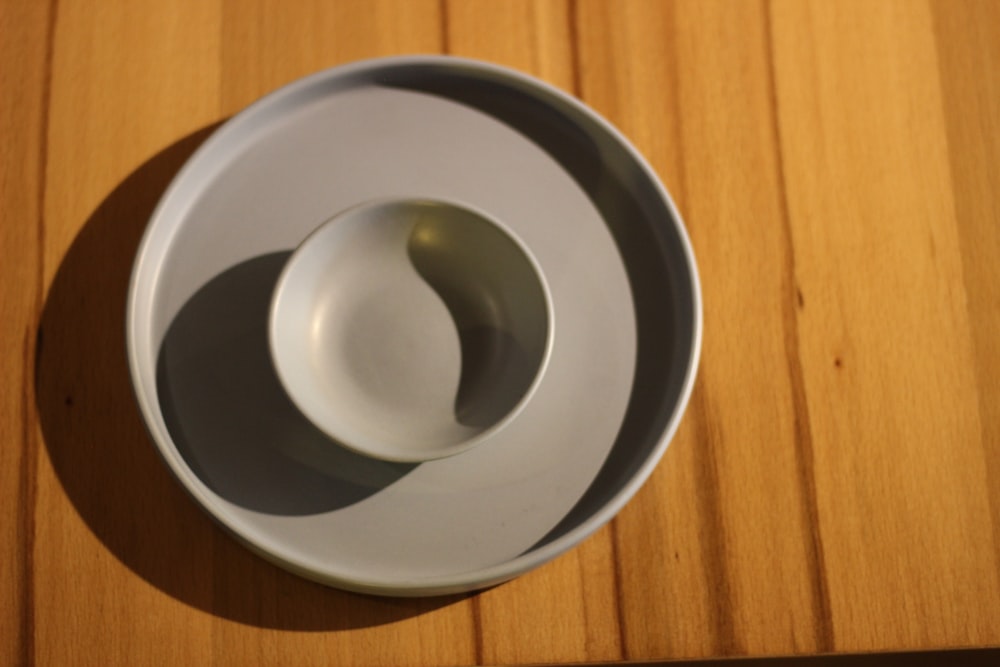 white ceramic bowl on white round plate