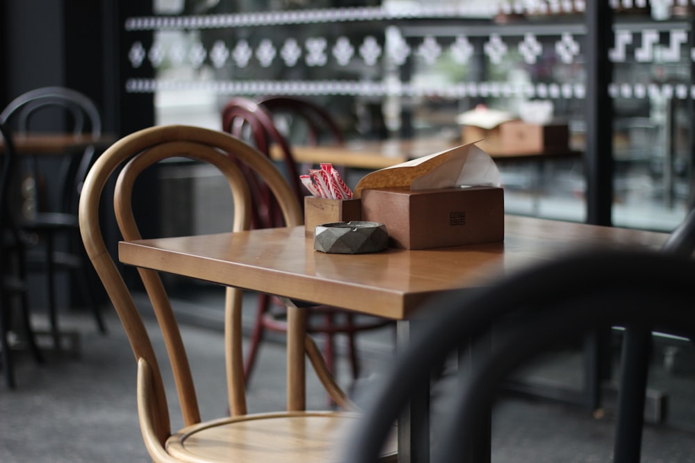 a wooden table topped with a box of fries