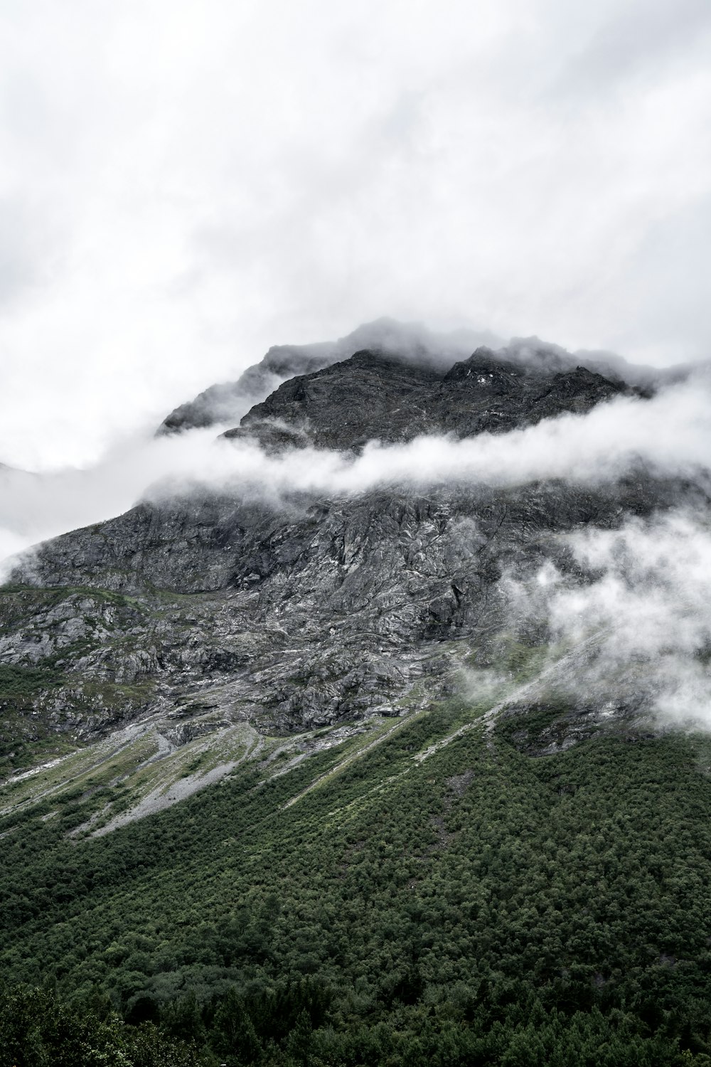 green and gray mountain under white clouds during daytime