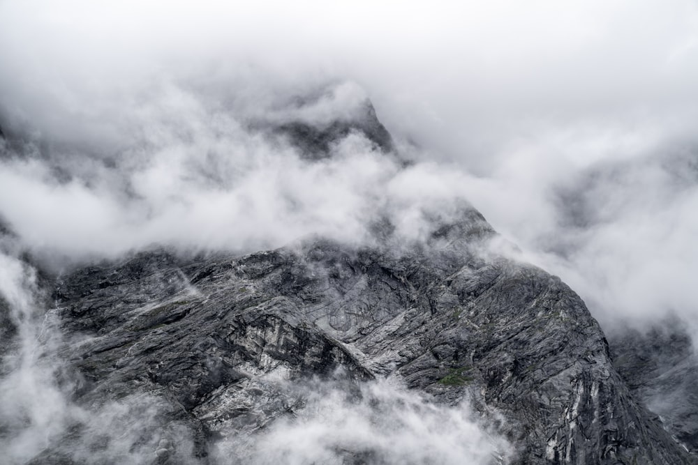 gray and black mountain under white clouds