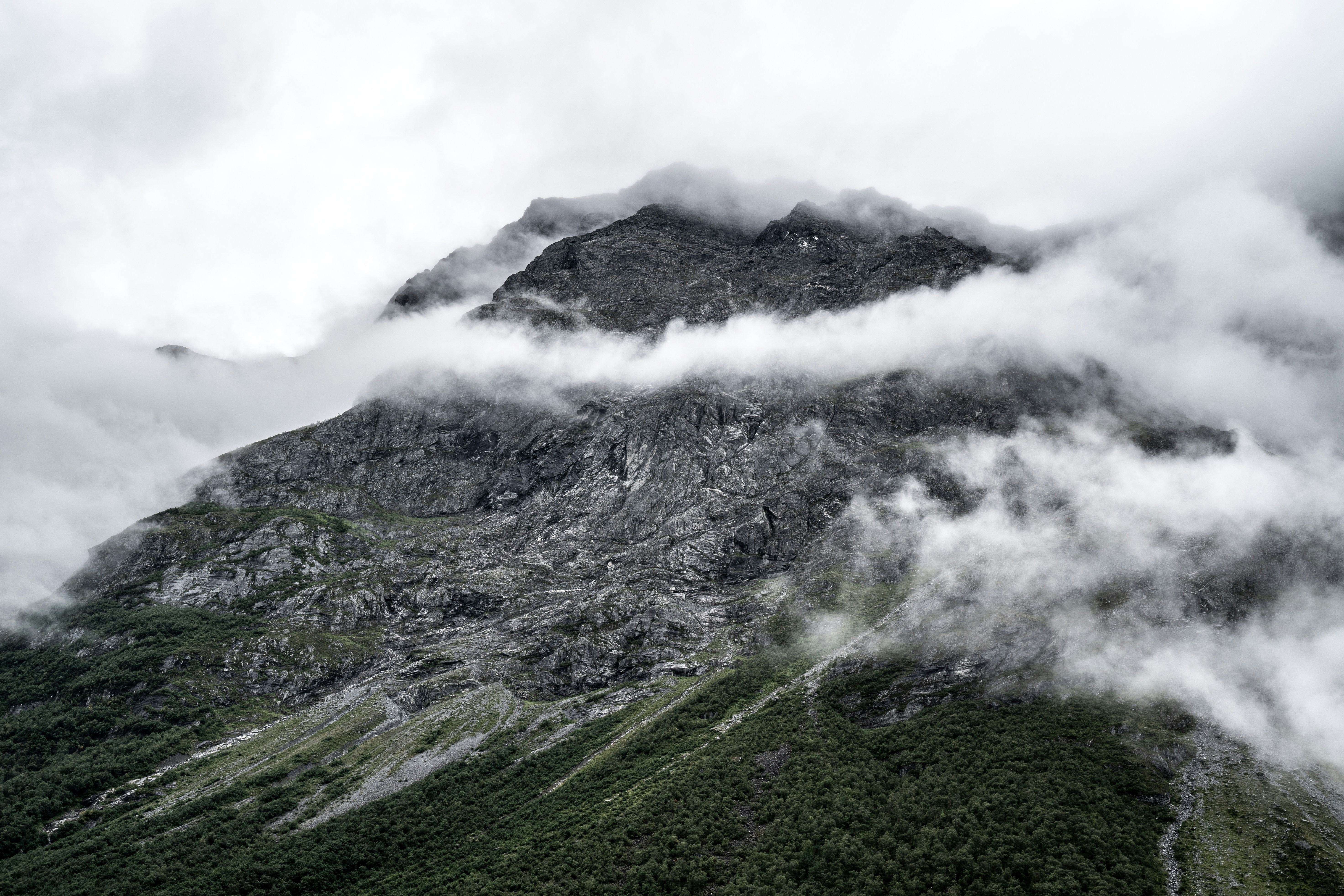 green and white mountain under white clouds during daytime