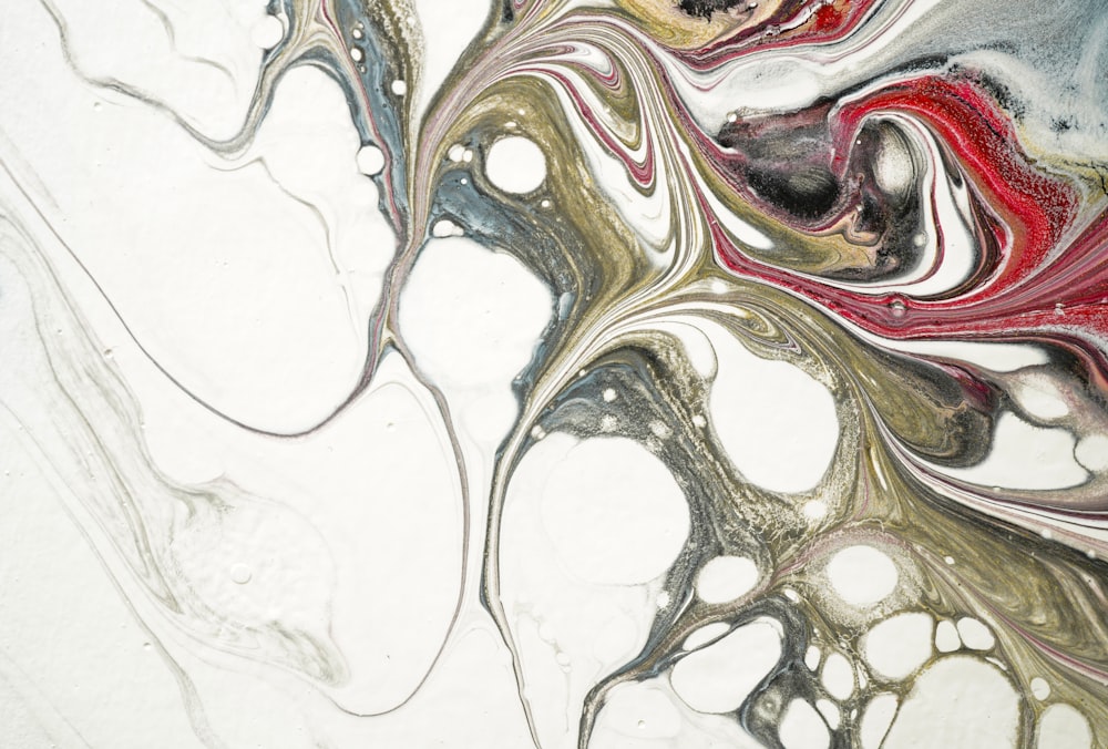 a close up of a marbled surface with red, white, and grey colors