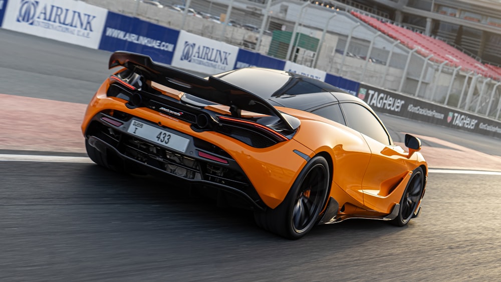 orange lamborghini aventador on a race track