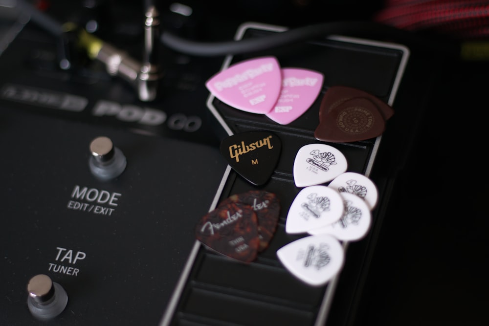 pink and black guitar pick