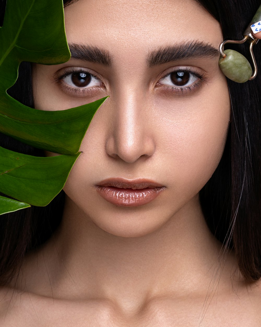 woman with green leaves on her head