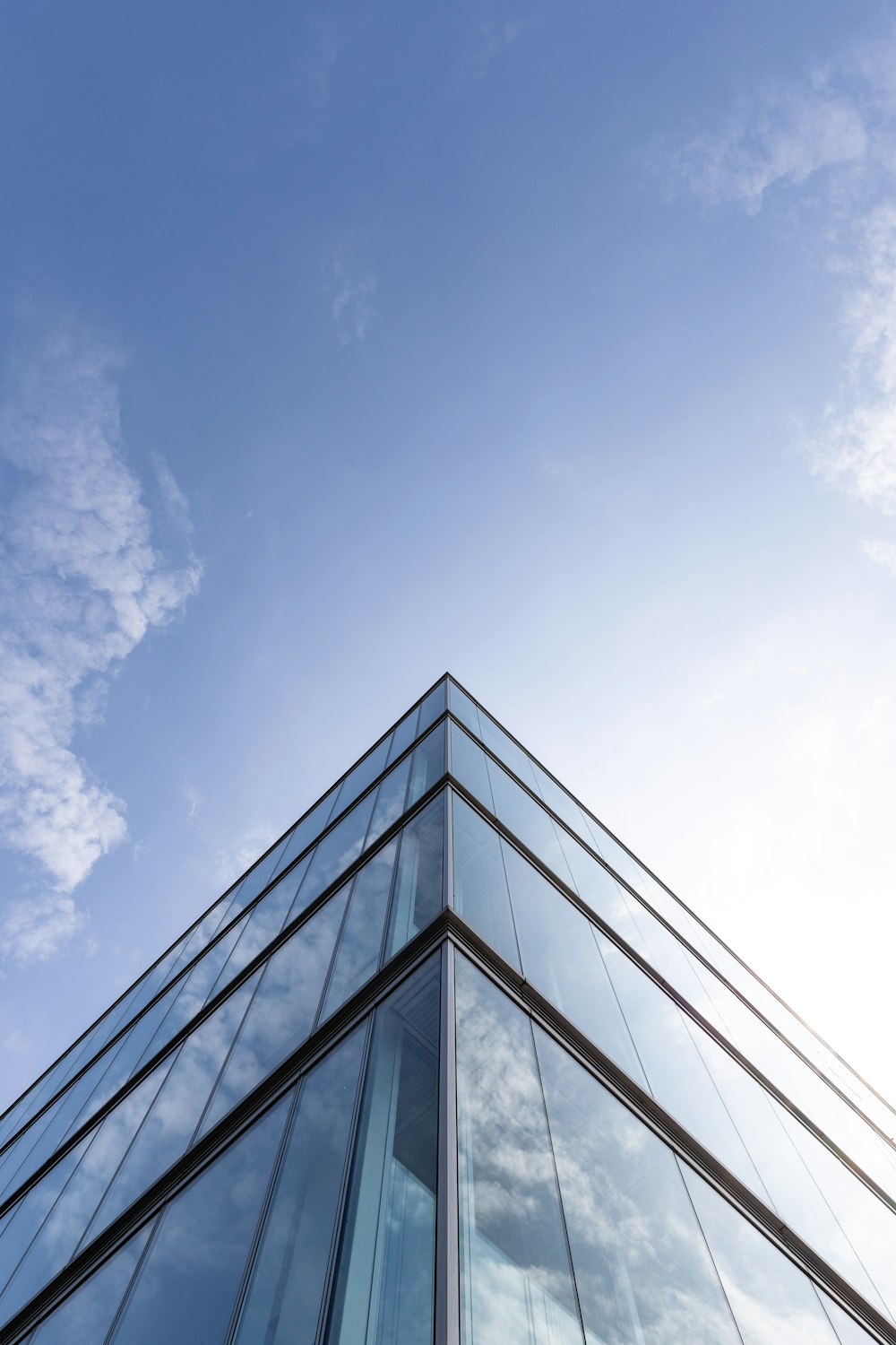 white clouds over glass building