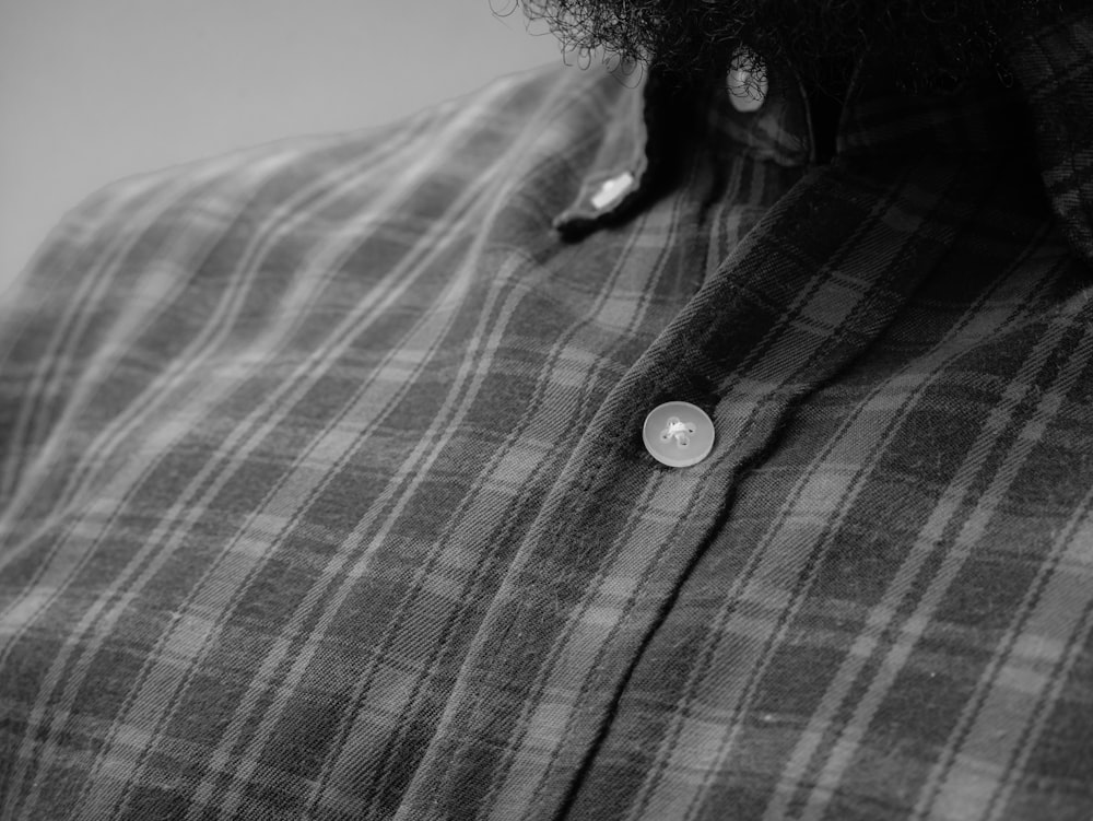 person wearing black and white plaid button up shirt