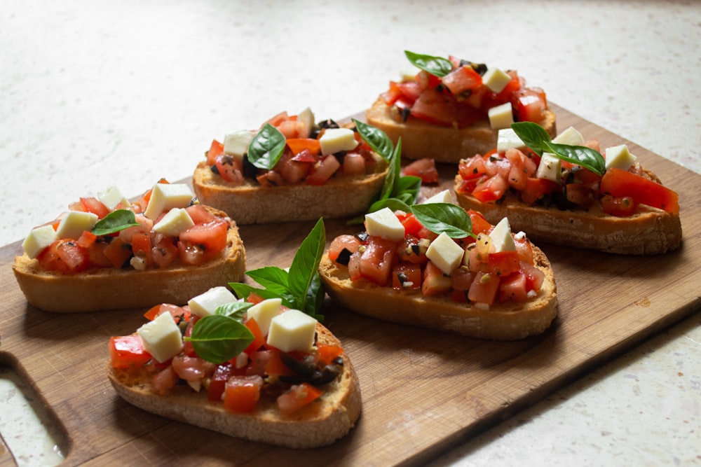 sliced tomato and green vegetable on brown wooden chopping board