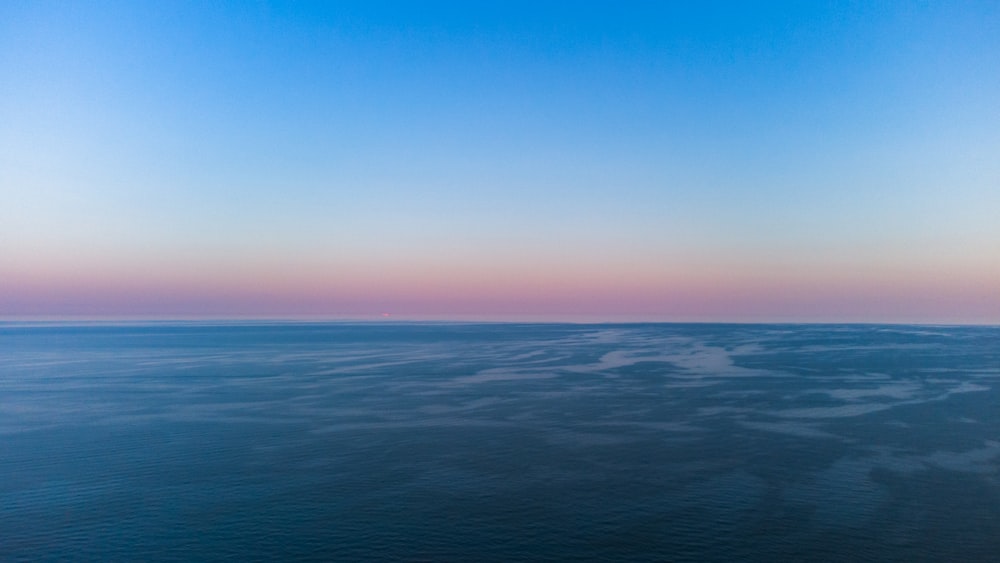 blue ocean water under blue sky during daytime