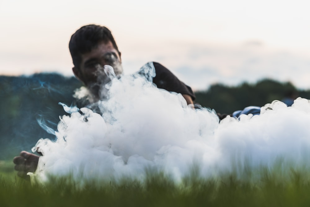 man in black shirt covered with white smoke