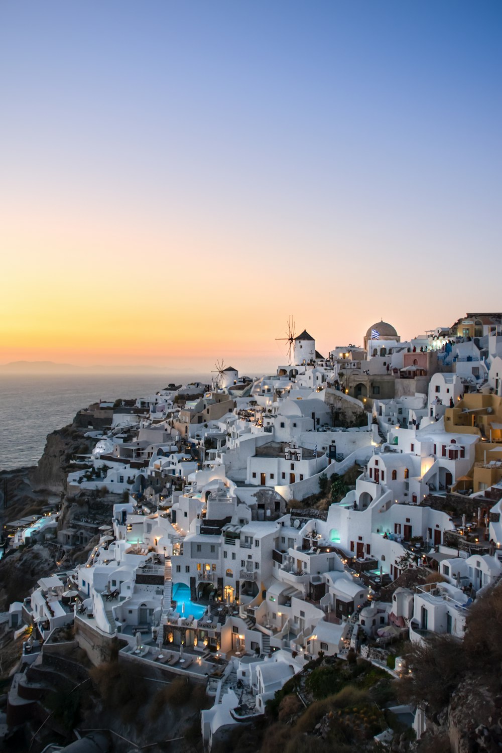 white and brown houses near body of water during daytime