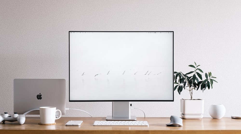 silver imac on brown wooden desk