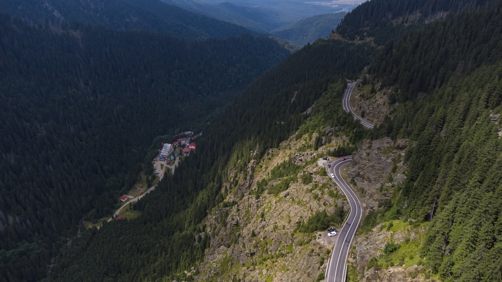 aerial view of road between green mountains during daytime