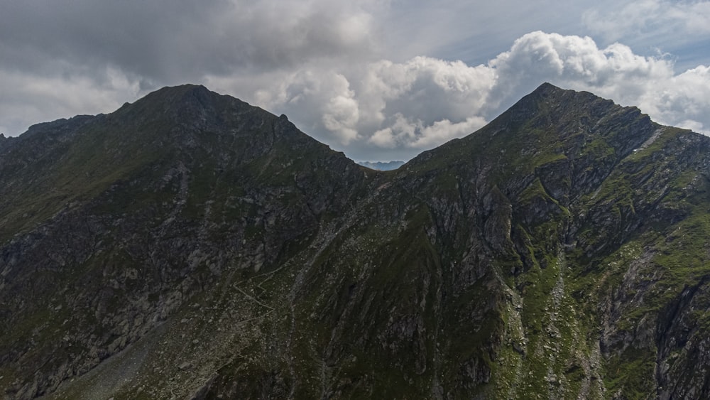 green and gray mountain under white clouds during daytime