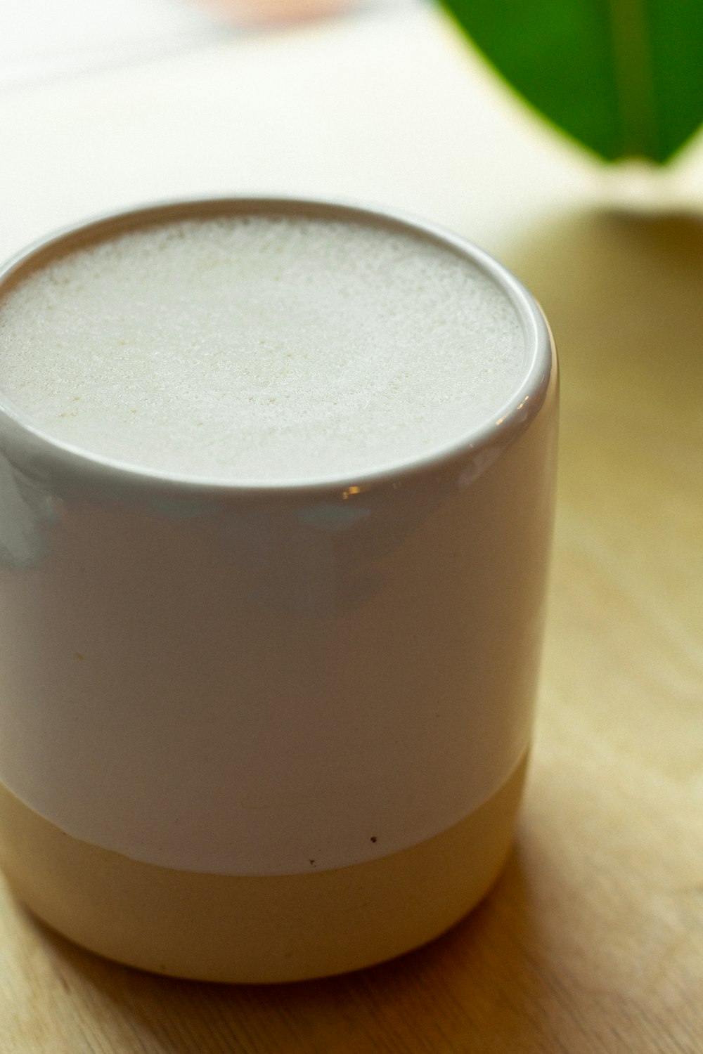 white and brown ceramic mug