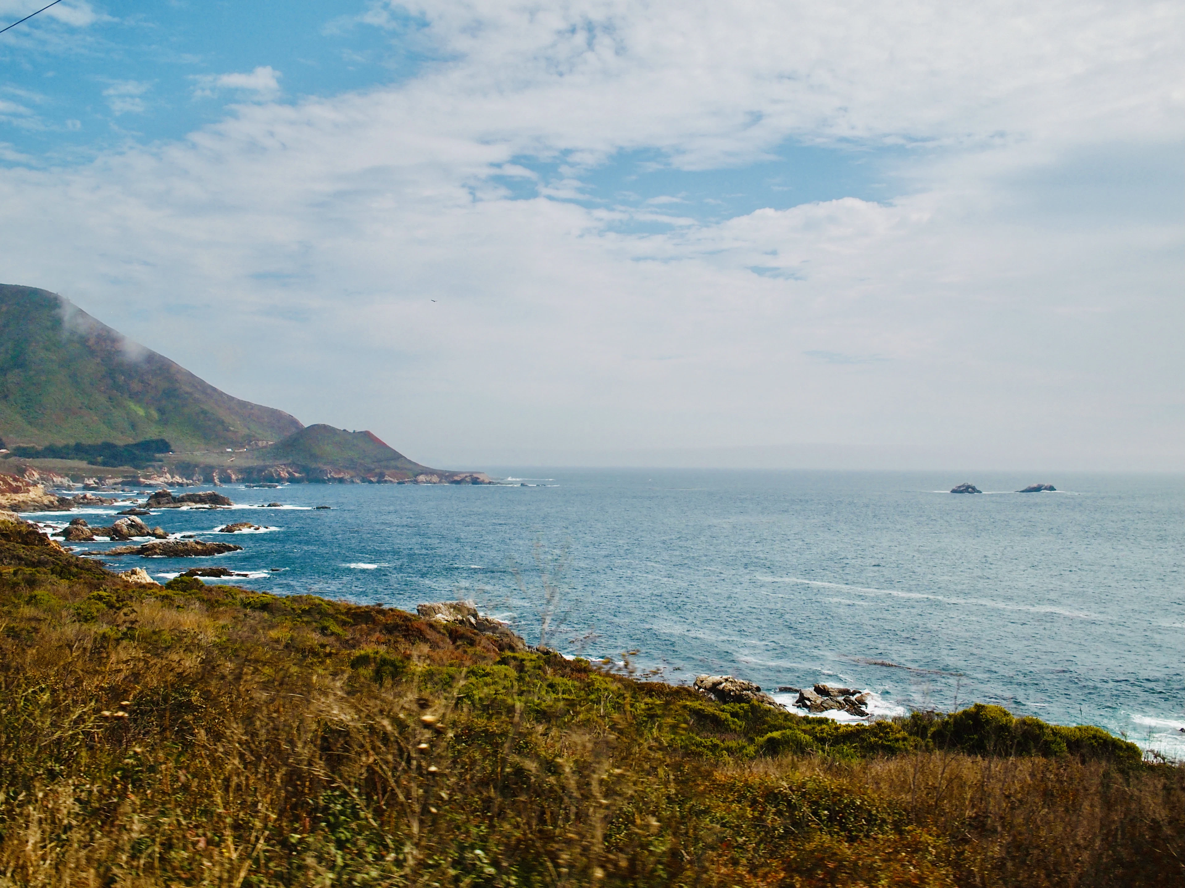 The Big Sur coast: cloud-wrapped hills, rocks and a calm Pacific