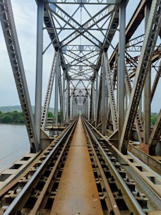 brown metal bridge over the river