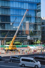 yellow and black crane near building during daytime