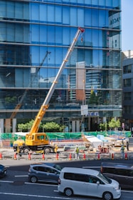 yellow and black crane near building during daytime