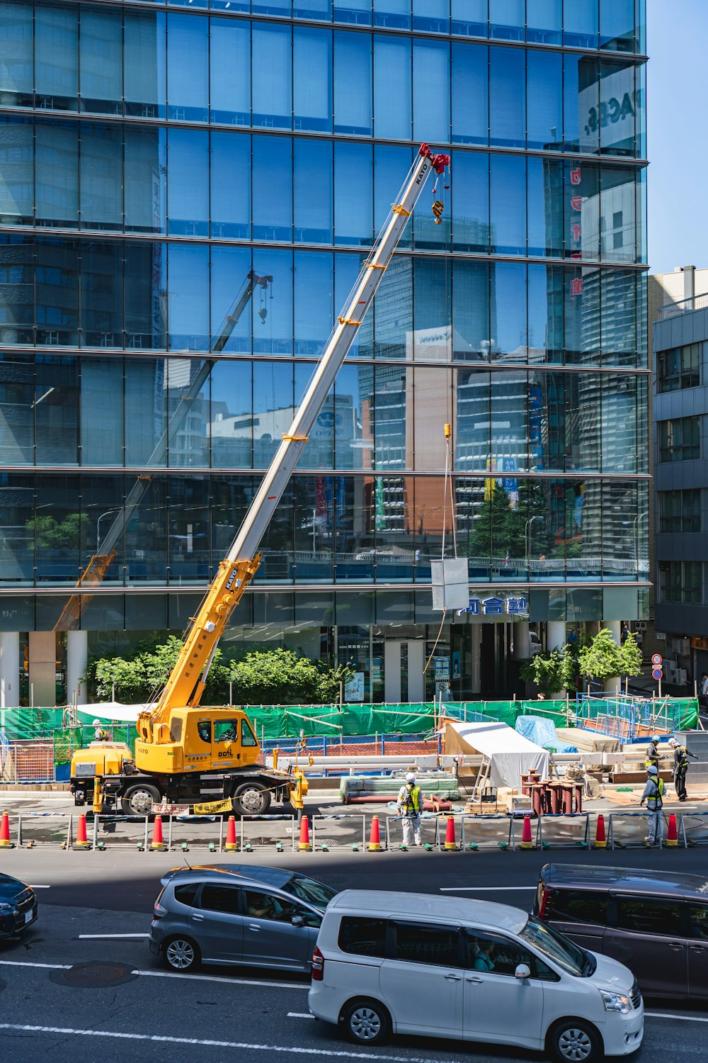 yellow and black crane near building during daytime