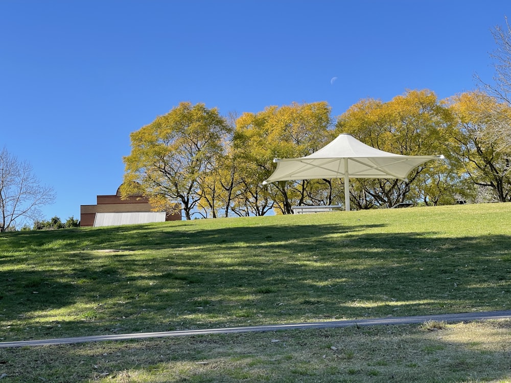 white and brown tent on green grass field during daytime