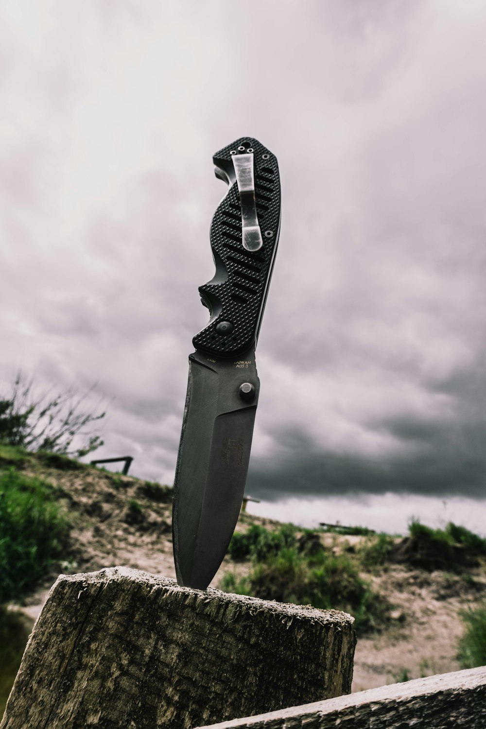 black and silver folding knife on brown rock