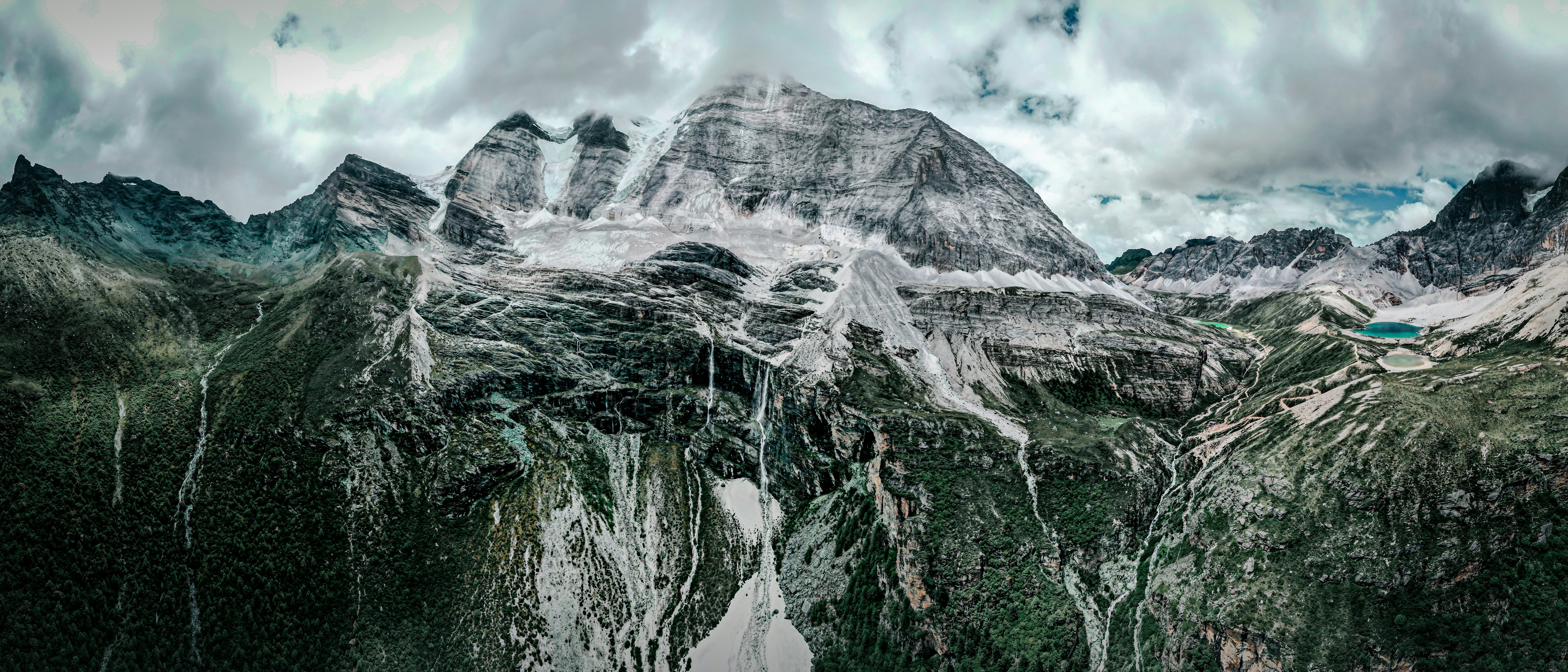 gray and white mountain under white clouds