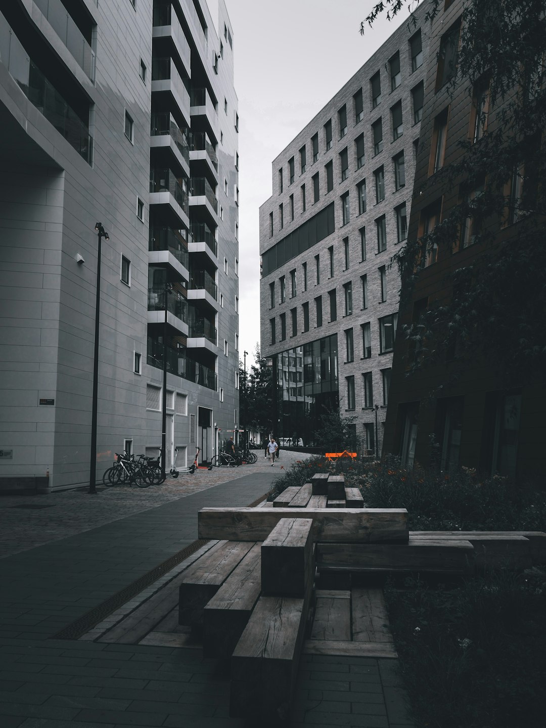 people walking on sidewalk near high rise buildings during daytime