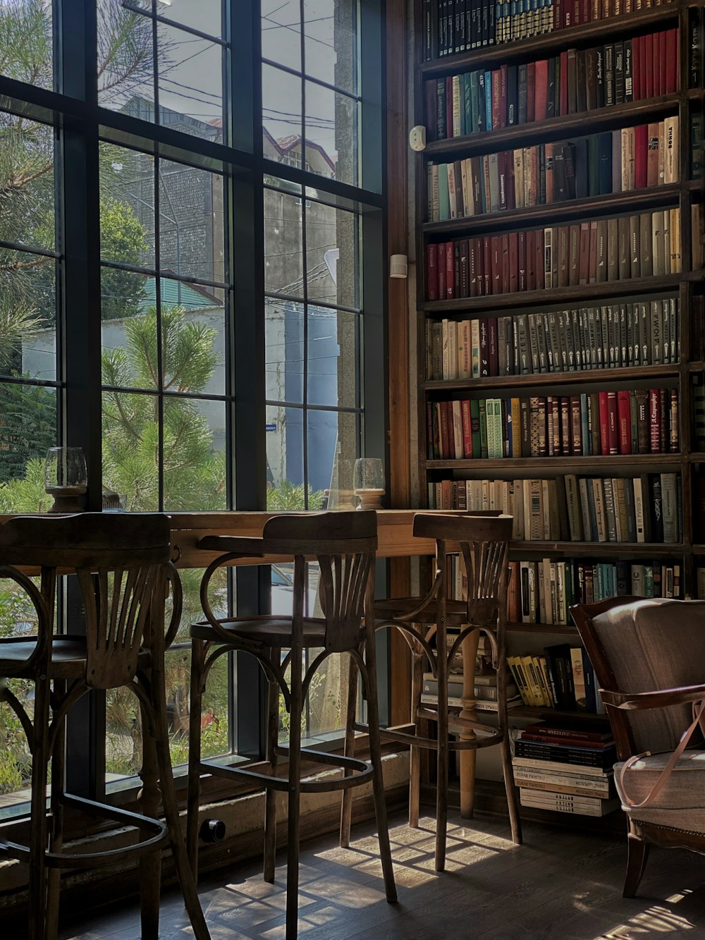 brown wooden chairs and table near window