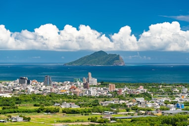 city near body of water under blue sky during daytime