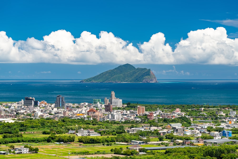 city near body of water under blue sky during daytime