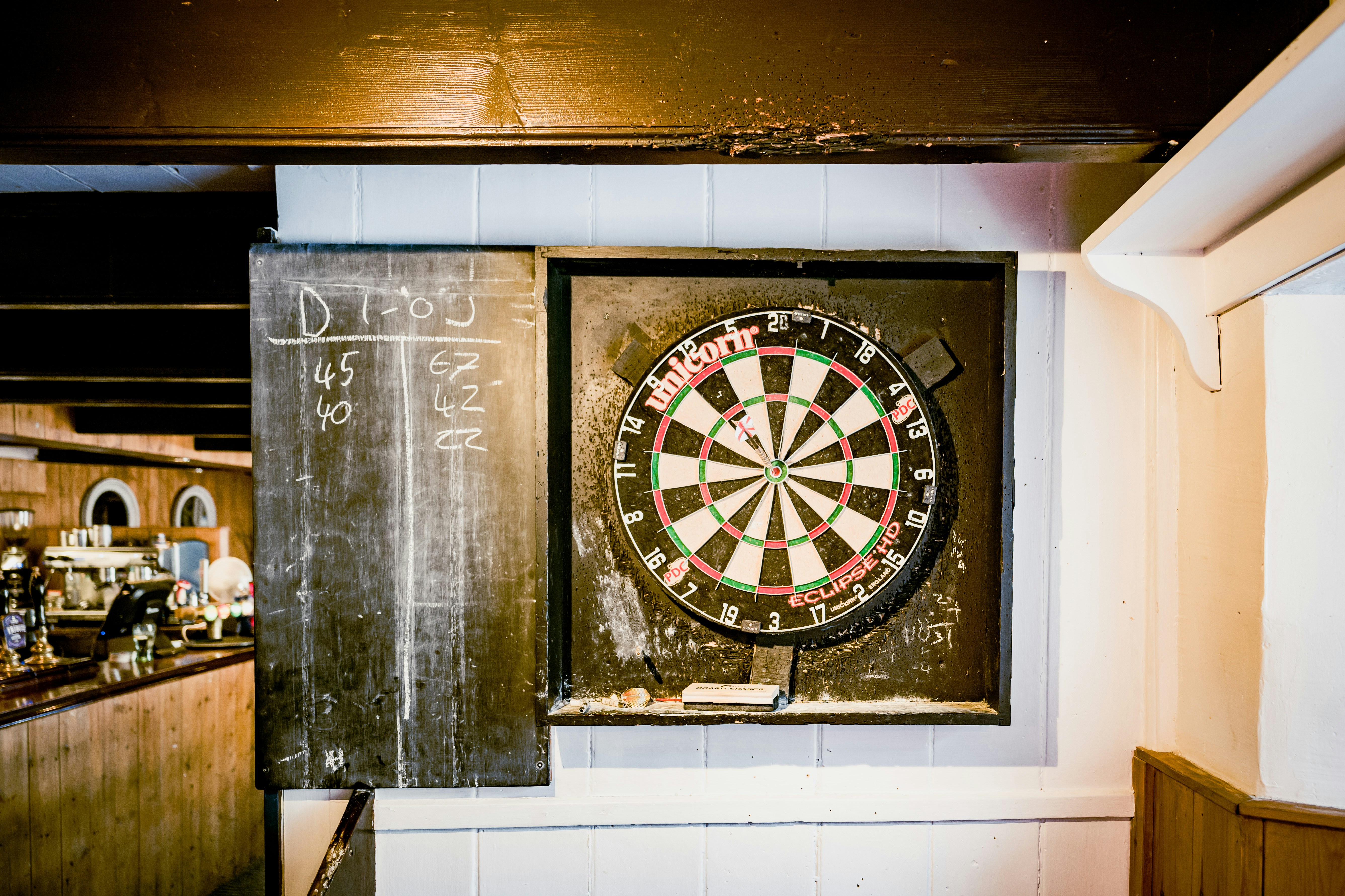 A dartboard and arrow with English flag in a pub in Cornwall, UK